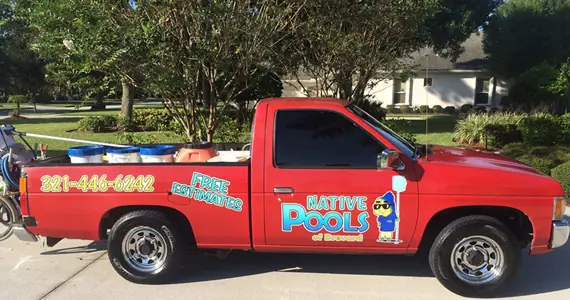 The red Native Pools of Brevard work truck with FREE ESTIMATES and 321-446-6242 lettered on the bed